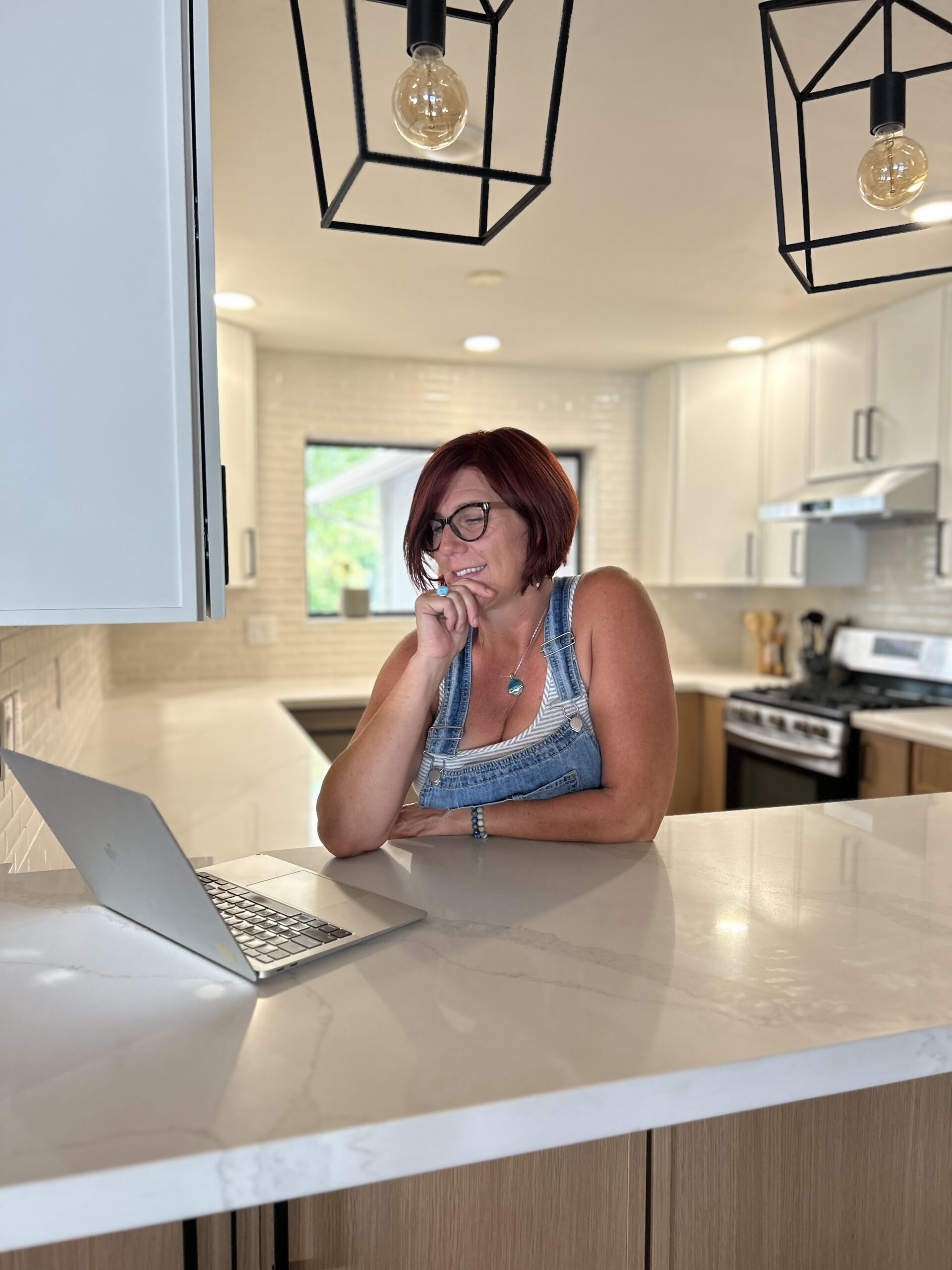 Audrey reviewing a remodel plan at a kitchen island
