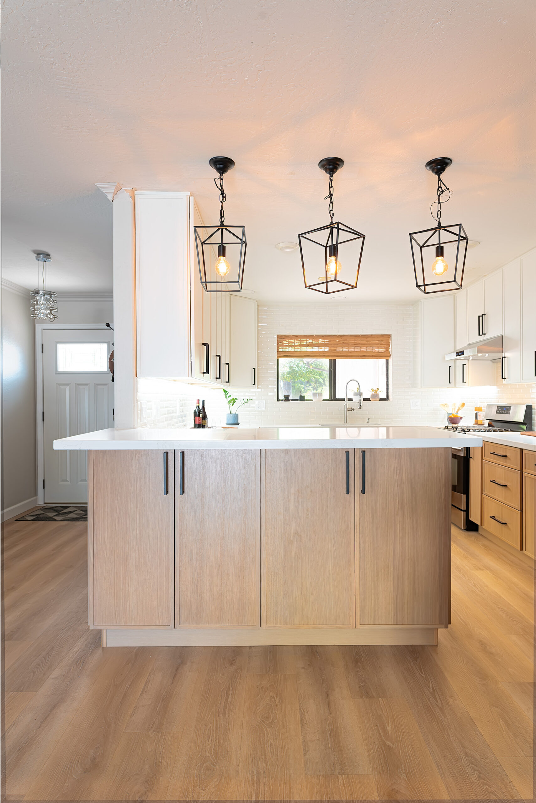 Remodeled Phoenix kitchen with custom cabinetry, stone countertops and island seating