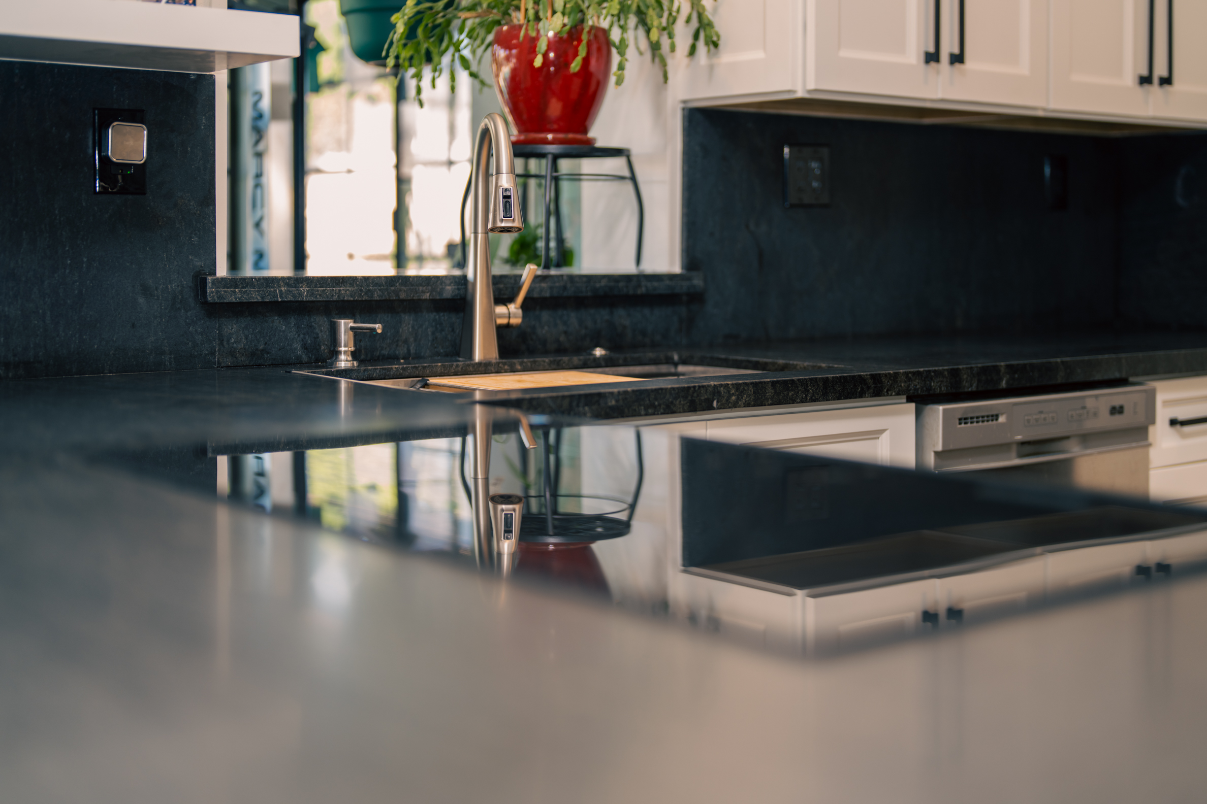 Close detail of honed stone countertop and brushed nickel faucet